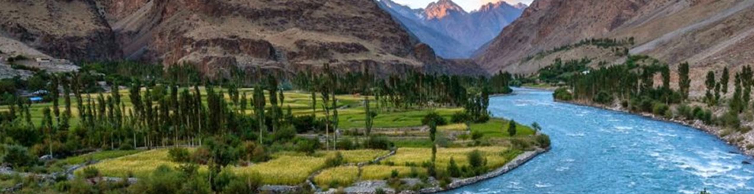 The mighty Indus River flowing through the mountainous landscape of Gilgit-Baltistan, serving as the region's primary waterway and lifeline for local communities