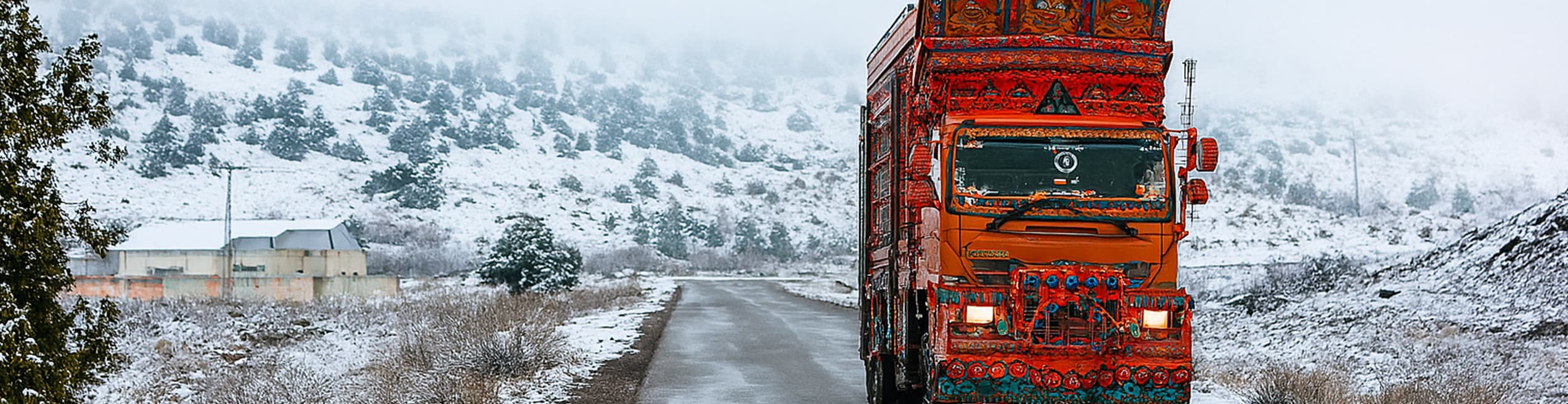 Colorful Pakistani truck driving on a snow-covered road in Quetta.
