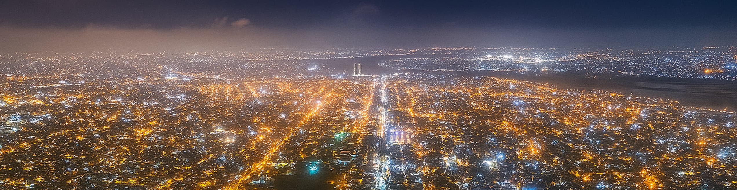 Night view of Karachi city with glowing lights and buildings.