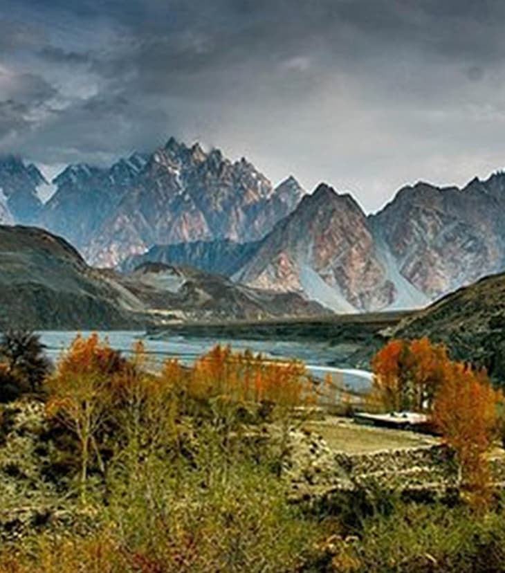 Diverse landscapes of Khyber Pakhtunkhwa featuring green valleys, snow-covered peaks, rivers, and forested hills under a bright sky.