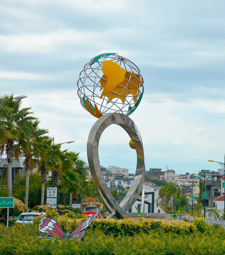 Decorative roundabout featuring an ornate globe monument as a centerpiece in Bahria Enclave Islamabad's landscaped intersection