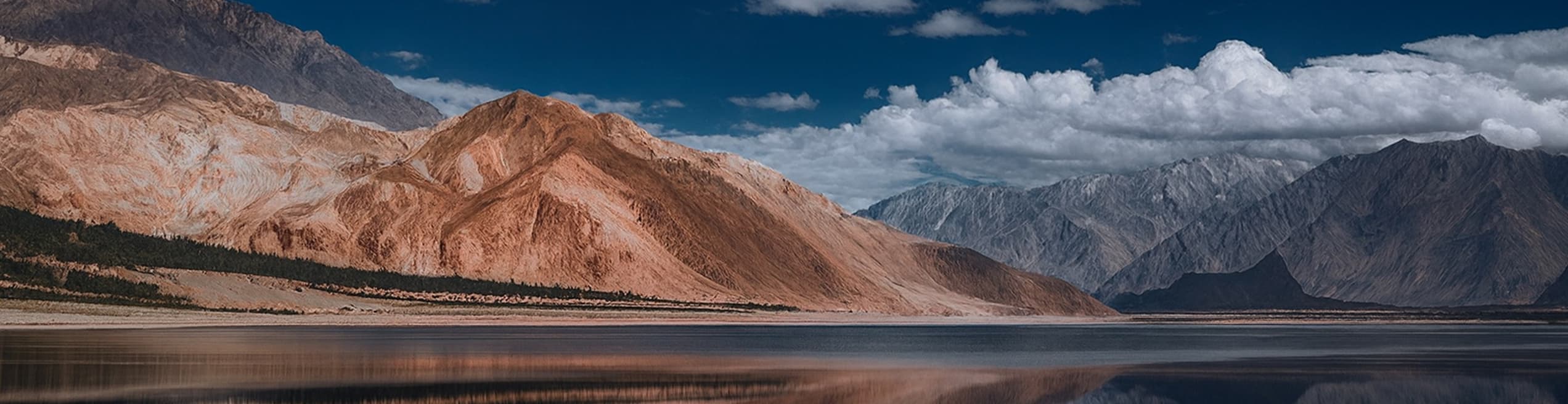 Sadpara Lake in Skardu surrounded by towering mountains and stunning natural scenery.
