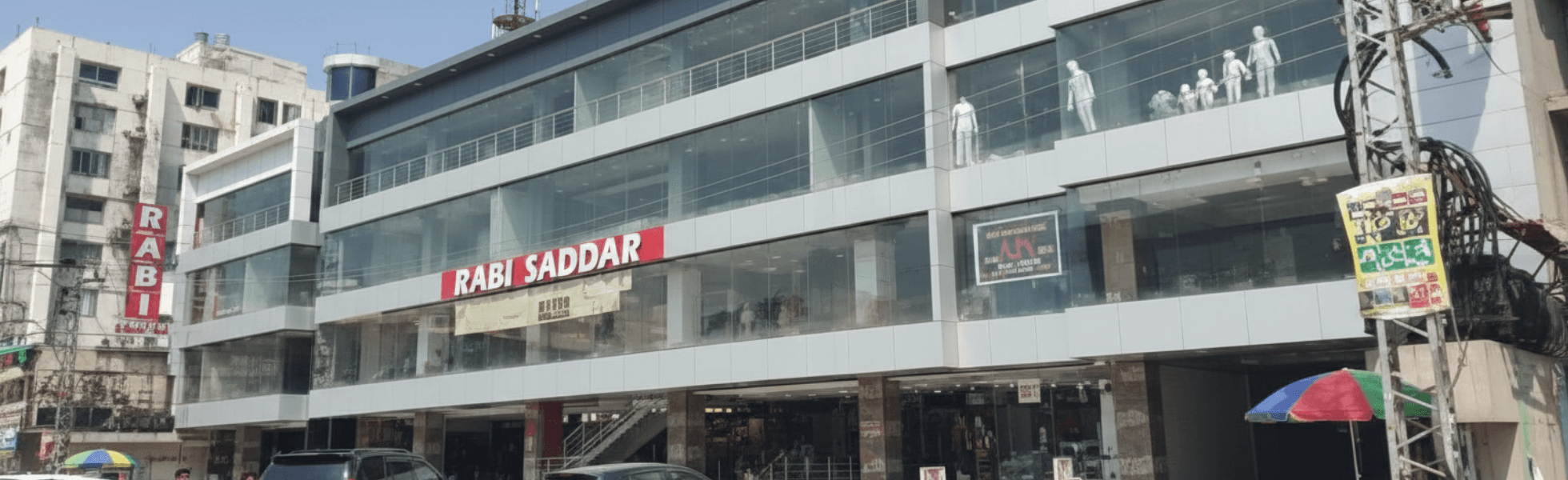 Wide banner view of Rabi Center Murree Road Rawalpindi showing shop fronts and shopping corridor, Cloth market in Rawalpindi near Rabi Center with fancy dress shops and dupatta shop displays