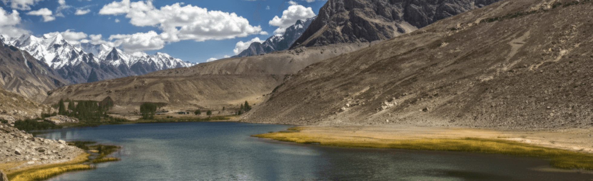 Wide banner view of Borit Lake resort area showing the lake and nearby hotel setting, Eco tourism Hunza scene at Borith Lake with changing weather and Passu approach route