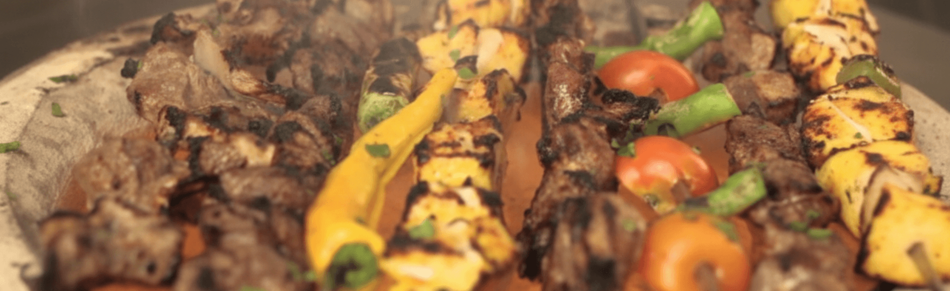 Wide banner view of a charsi tikka restaurant counter with grills, seating, and serving area, Charsi tikka University Road vibe with menu board style setting and Khyber charsi tikka shop feel