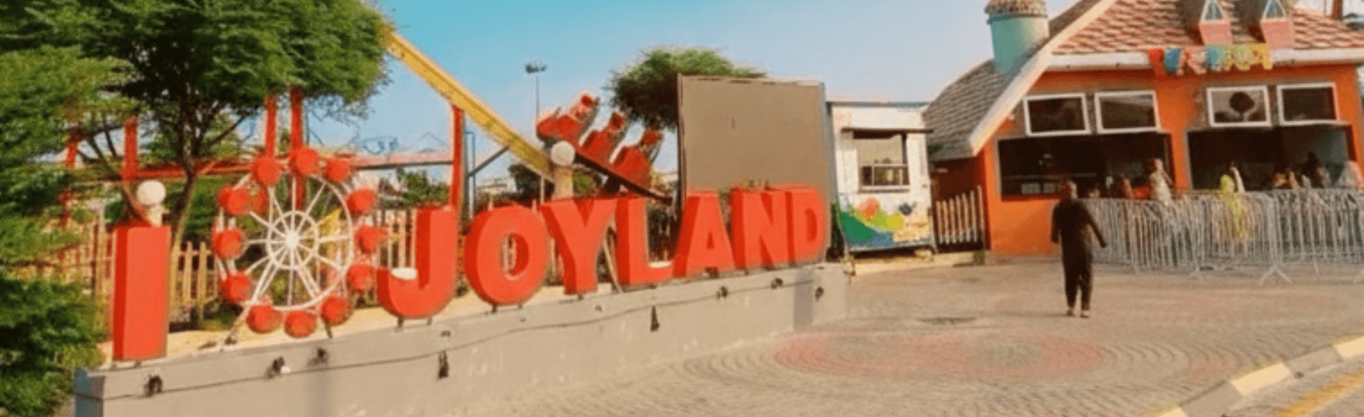 Wide banner view of Joyland Rawalpindi theme park in Ayub Park with multiple rides, Joyland Rawalpindi ticket price and timings information area with entrance and crowd