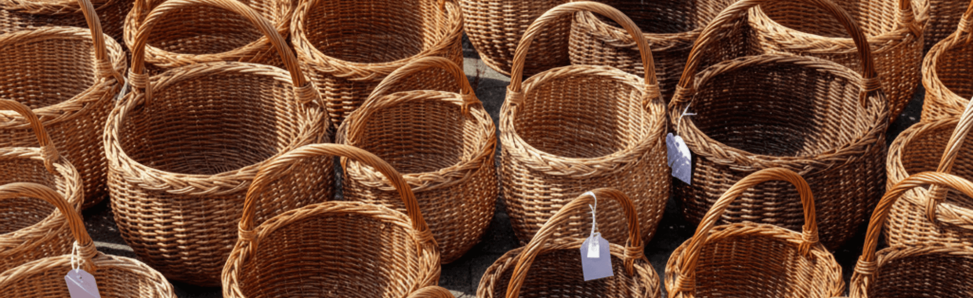 Wide banner view of handmade baskets arranged as traditional crafts and cultural items, Traditional products Gilgit Baltistan style basket display highlighting eco-friendly crafts