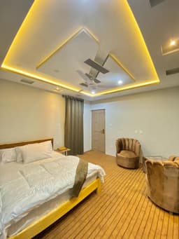 Double room wide shot with sofa seating in Skardu, Hygienic bedroom interior at Chogori Guest House near Sadpara Road