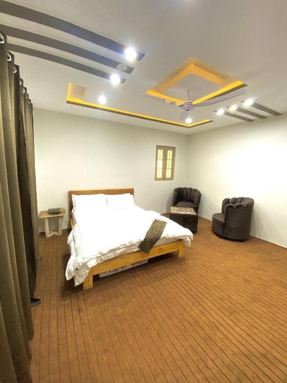 Second bedroom wide shot in Skardu guest house suite, Clean and comfortable room setup at Chogori Guest House Skardu