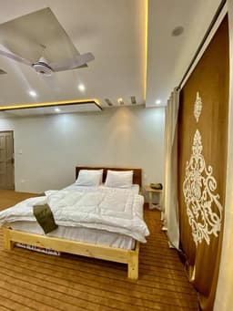 Deluxe twin room wide shot with sofa sitting area in Skardu, Cozy twin bedroom at Chogori Guest House near Sadpara Road