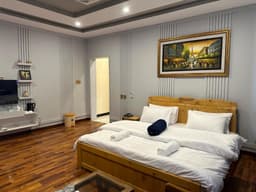 Twin bed deluxe suite bedroom with large window in Skardu, Areena Hotel Skardu room with air conditioning