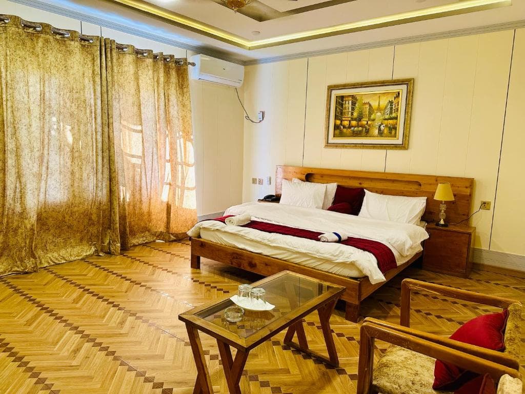 Twin beds with wide window and natural light in Skardu hotel, Deluxe suite room interior at Areena Hotel Skardu