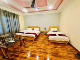 Standard room with two single beds in Skardu, Twin bed layout with mountain view balcony