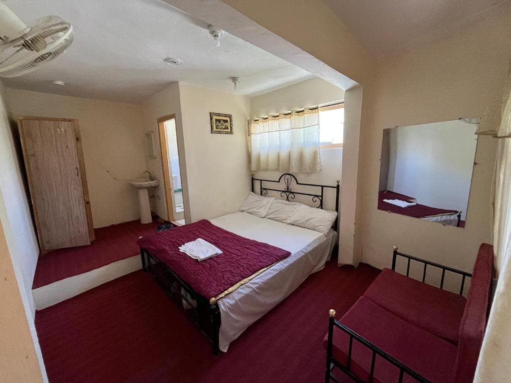 second angle of double bed room in Skardu, cozy hotel room with clean bedding