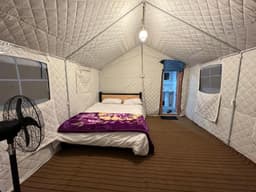 small double room with seating area in Skardu, Valhalla Guest House room interior