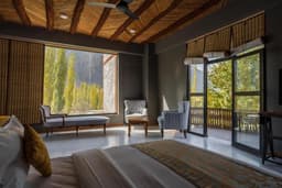 King bedroom with balcony and sofas near window in Skardu, Mountain view room at PC Legacy