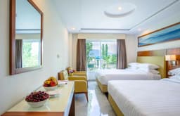 Large room with two double beds and mountain view window in Skardu, Deluxe room with sofa and fruit table at Avari Xpress