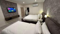 Two double beds with AC and LED in Skardu hotel room, Spacious family bedroom at Qayam Skardu