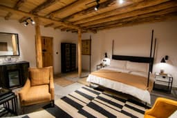 Deluxe king room with large bed in Skardu, Broq Resort bedroom with mountain setting