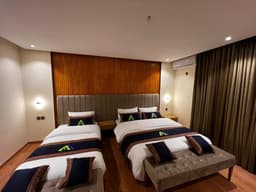 Deluxe triple room with multiple beds in Skardu, Apex Hotels and Resorts Skardu spacious bedroom