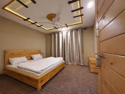 Queen room with comfortable bed in Skardu, HIKK Inn Skardu bedroom with natural light