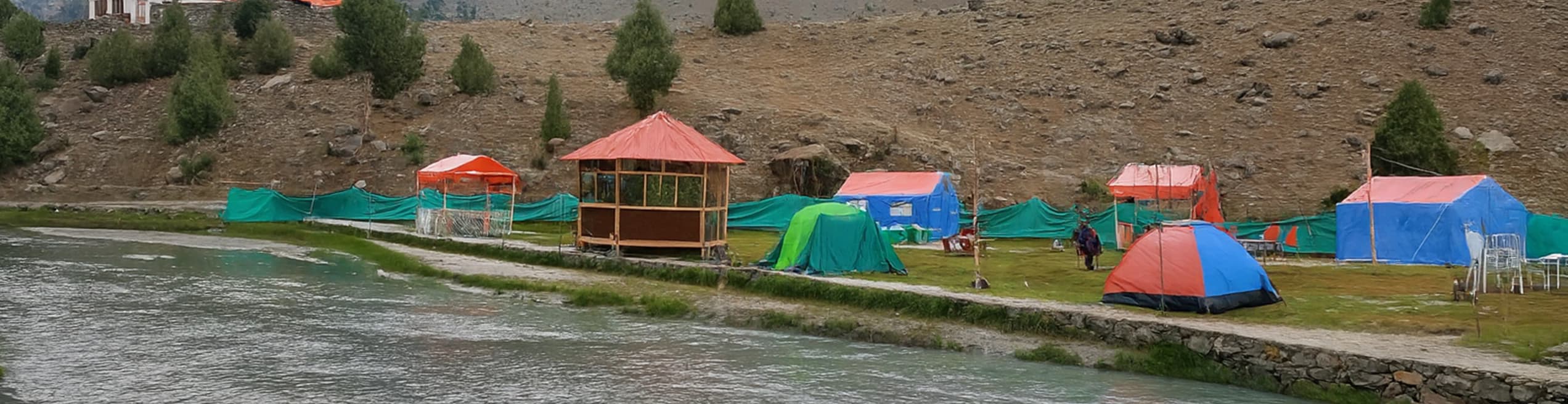 Camping Site in Basho Valley, Skardu Scenic camping site in Basho Valley, Skardu, with tents set against green meadows and surrounding mountains.