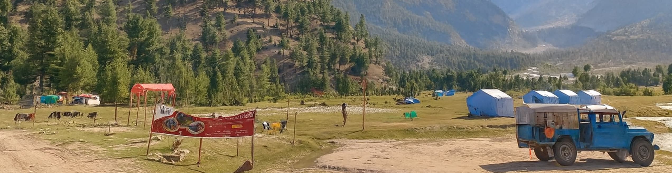 Beautiful Mountain Plains with Camps in Basho Valley Lush green plains in Basho Valley surrounded by mountains, featuring camping tents set against the scenic backdrop.