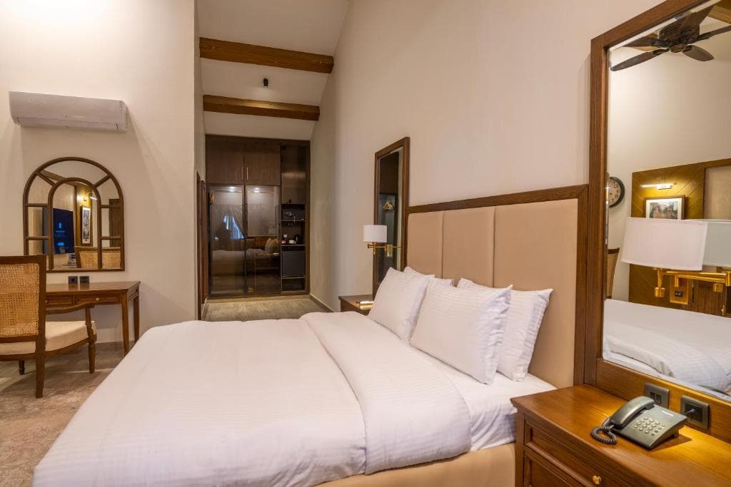 Modern Queen Bedroom Interior in K2 Hotel by Green Pak Skardu Modern hotel bedroom with queen bed in Skardu, Clean deluxe room with air conditioning and WiFi at K2 Hotel